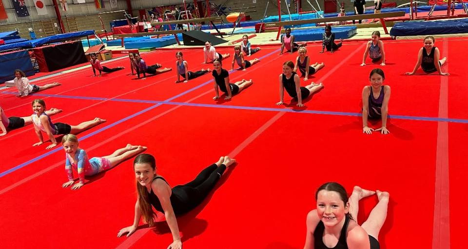 3 gymnasts in a skill