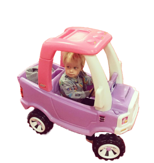 Small child in a ride-on car
