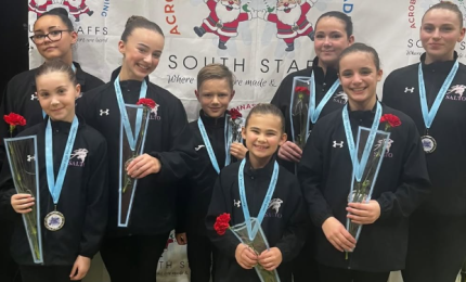 Eight Acrobatic Gymnasts each holding a red rose 